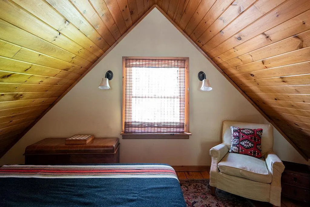 loft bedroom with wood ceiling