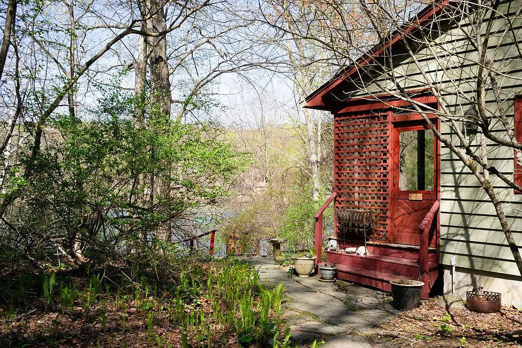 red door to the screened-in porch of a cottage