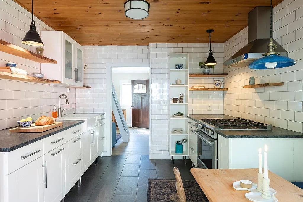 kitchen with oversized, white subway tile, white cabinets