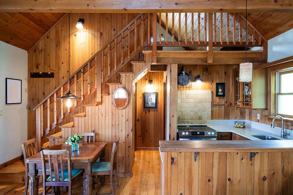 cottage with wood paneling, open plan kitchen