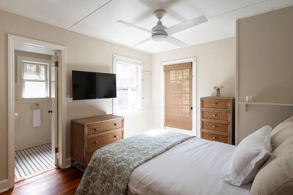 bedroom with ceiling fan and en suite bath