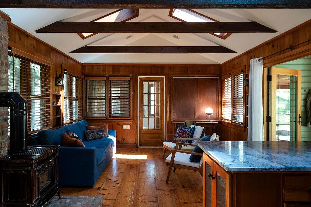 living room with paneling, skylights