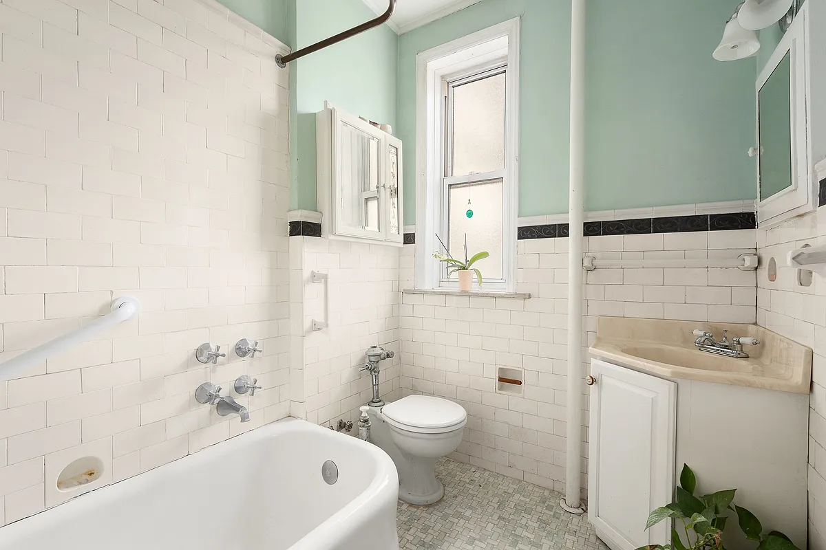 bathroom with white wall tile and fixtures