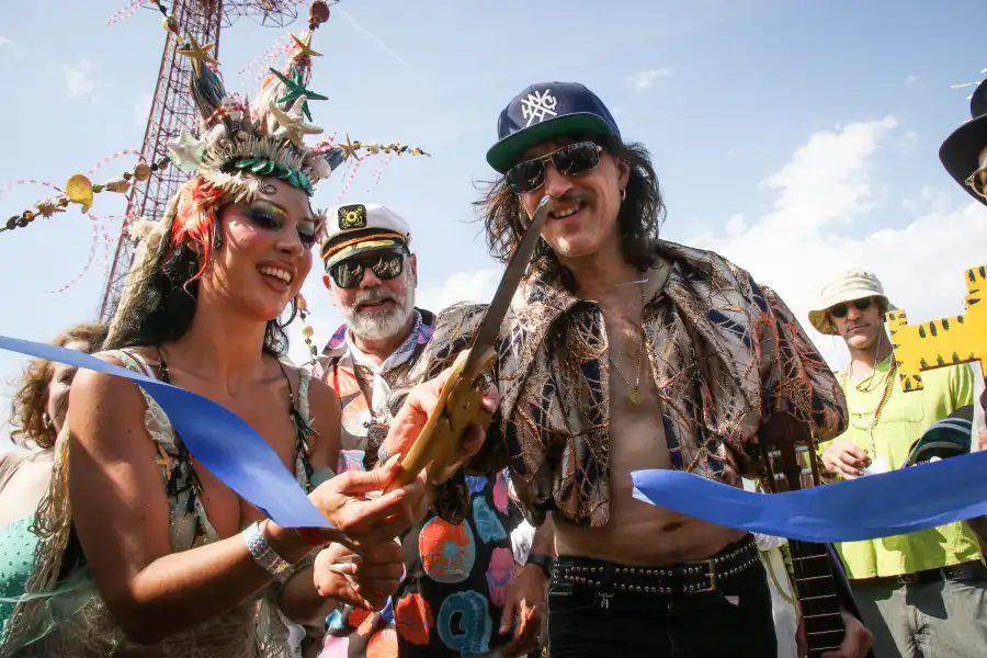 Coney Island USA artistic director Adam Rinn leads the summer season beach blessing procession alongside King Neptune, Eugene Hütz, and Queen Queenie Sateen.