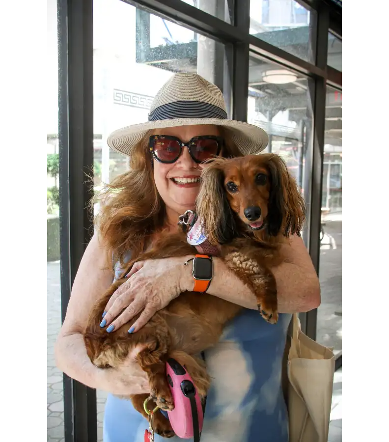 A Bay Ridge voter arrives at Shore Hill Housing with her loyal companion in tow to cast her ballot in Tuesday’s primary election.