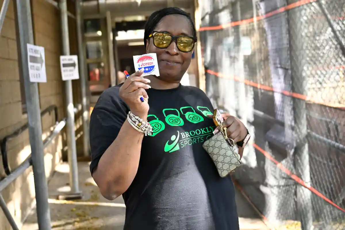 A woman proudly displays her “I Voted” sticker after casting her ballot at a Spring Creek polling site during Tuesday’s primary election.
