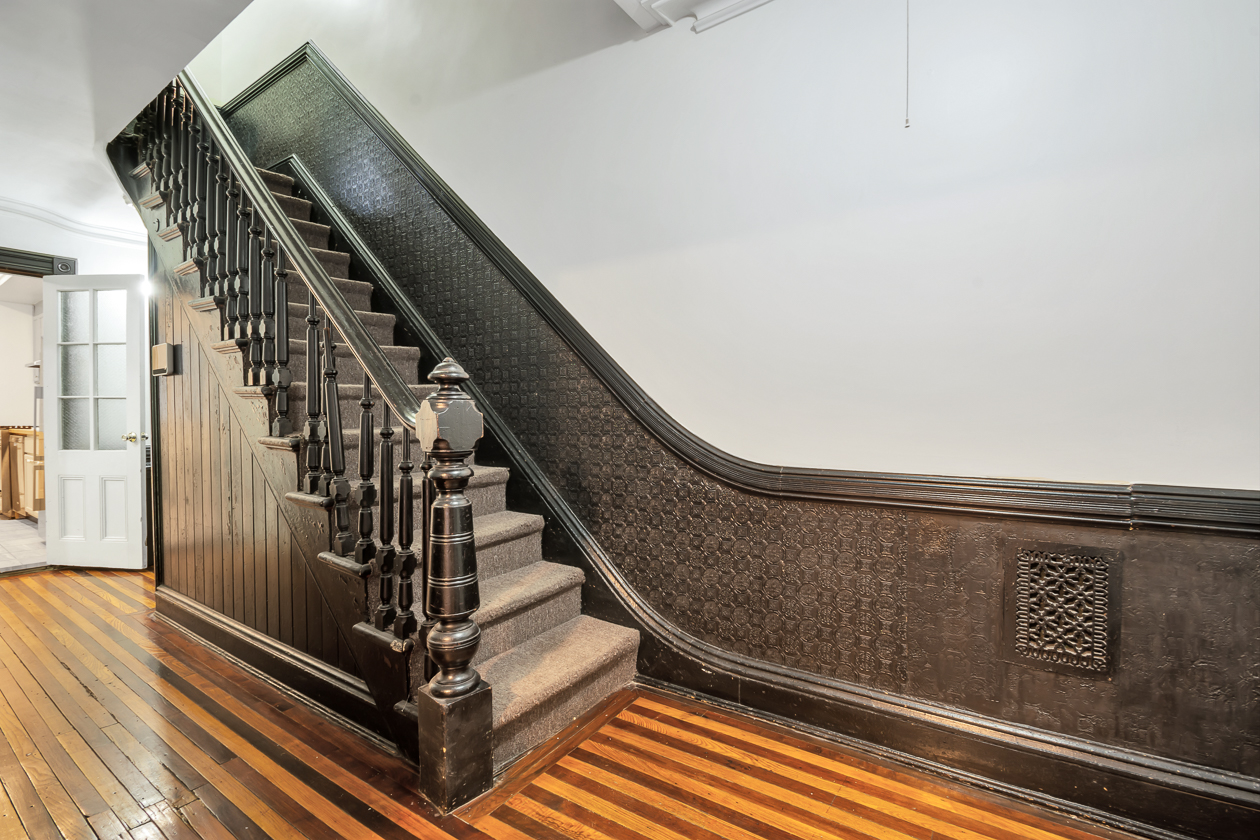 garden level hall with wood floor, wainscoting, stair