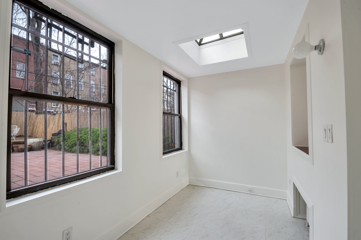 office with a skylight and two windows