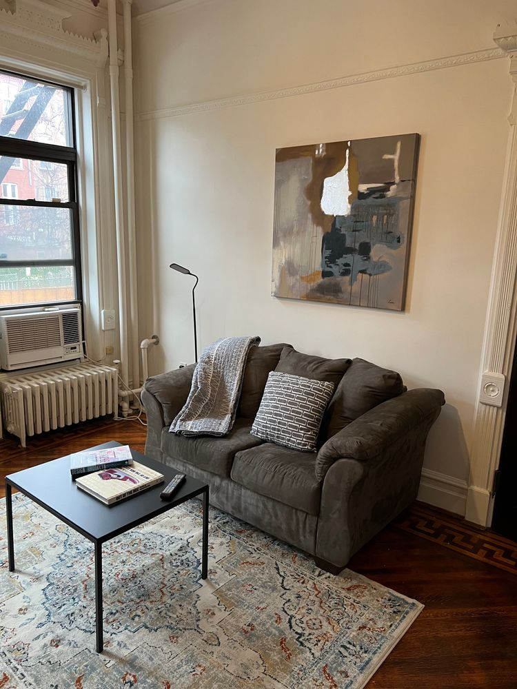 living room furnished with sofa and carpet