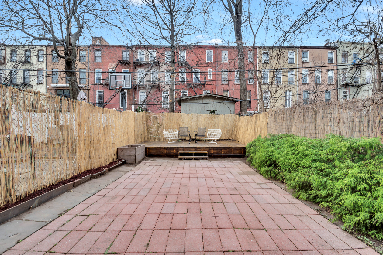 rear yard with paved patio and raised platform at rear