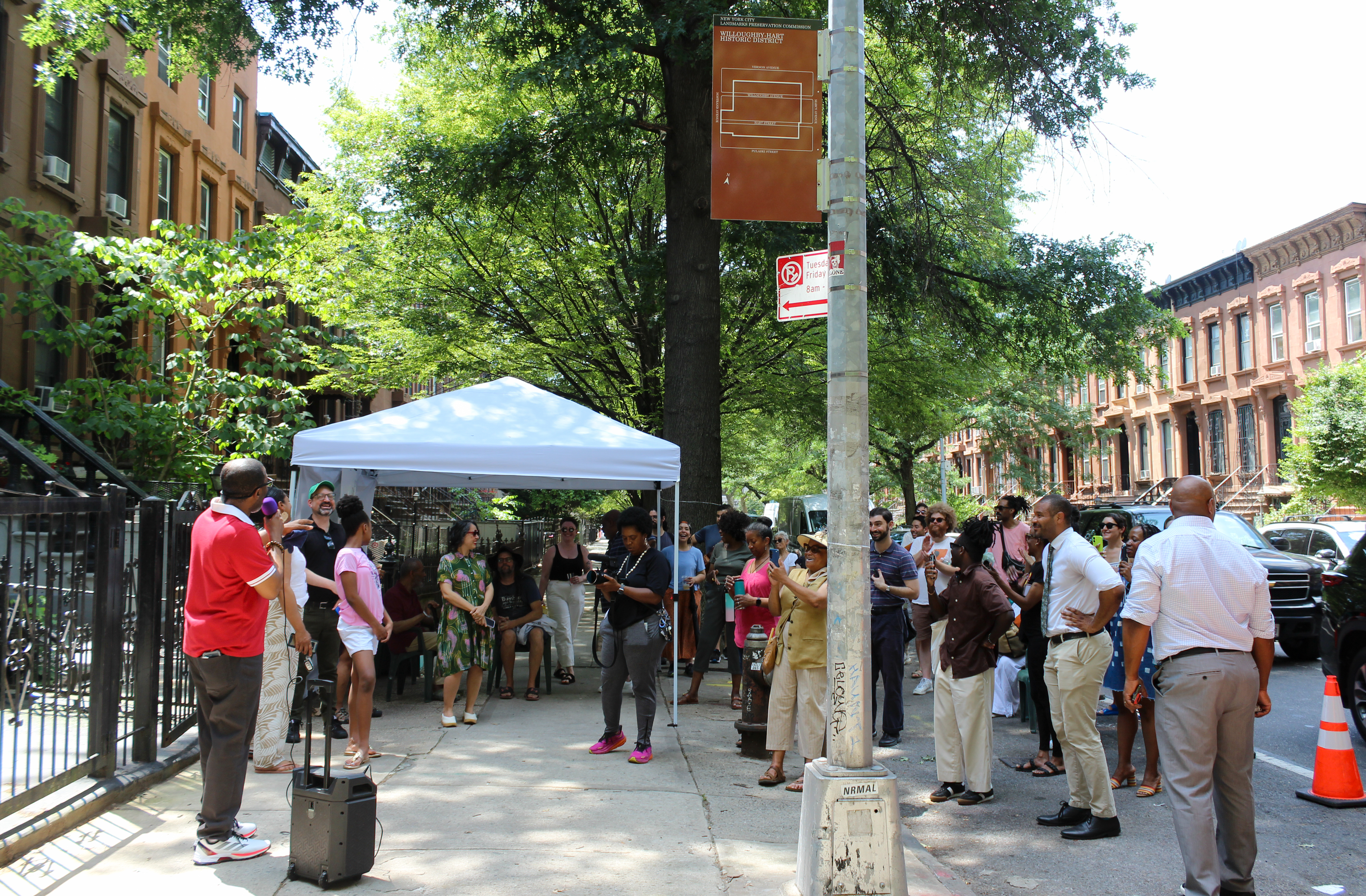 people talking at the sign unveiling ceremony
