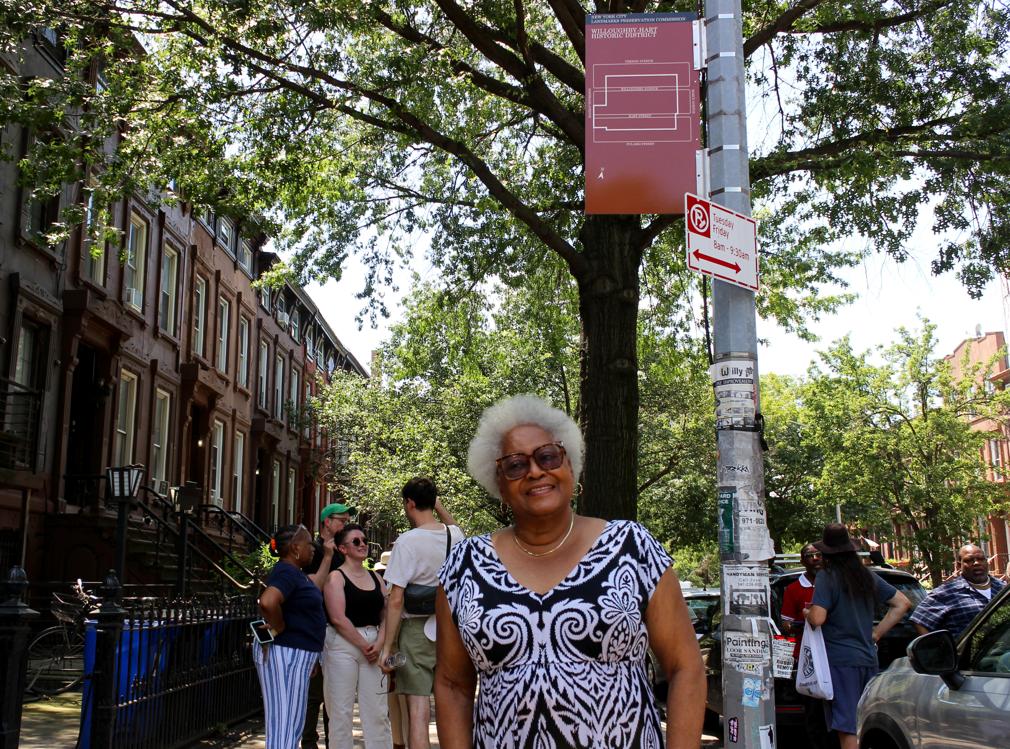 a woman posing by the sign