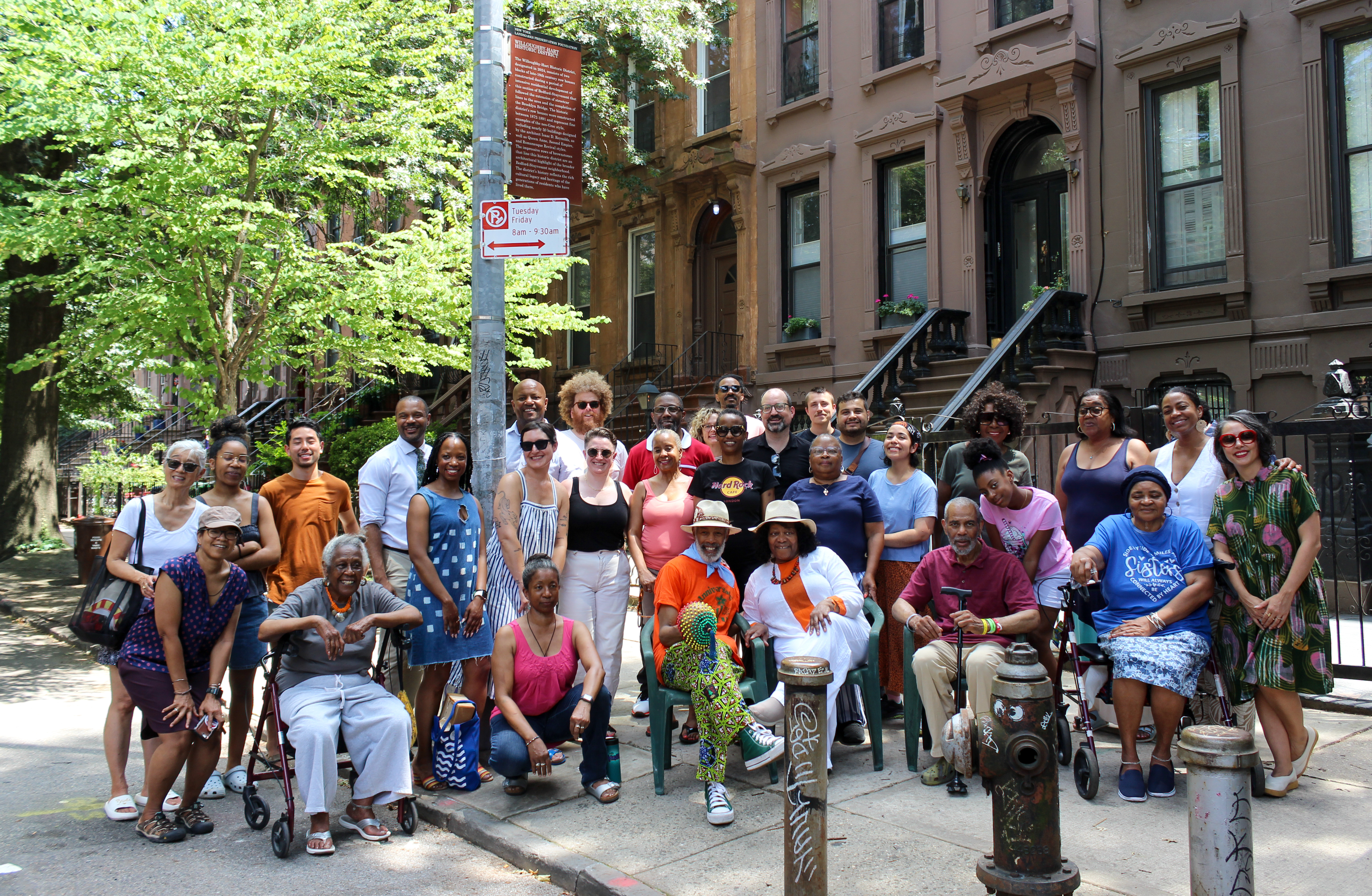 neighbors and advocates posing by the historic districts sign