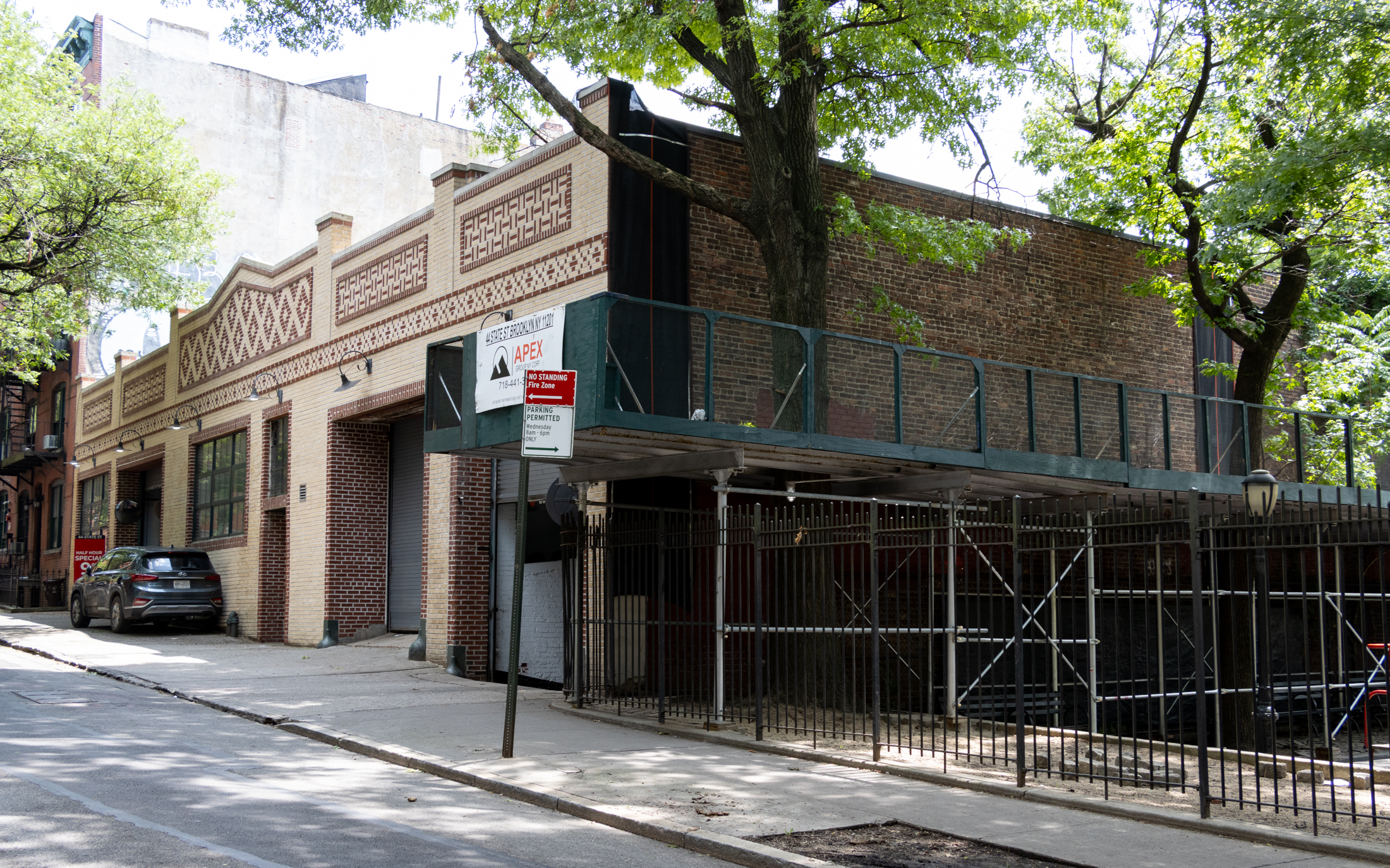 brick garage building next to a park