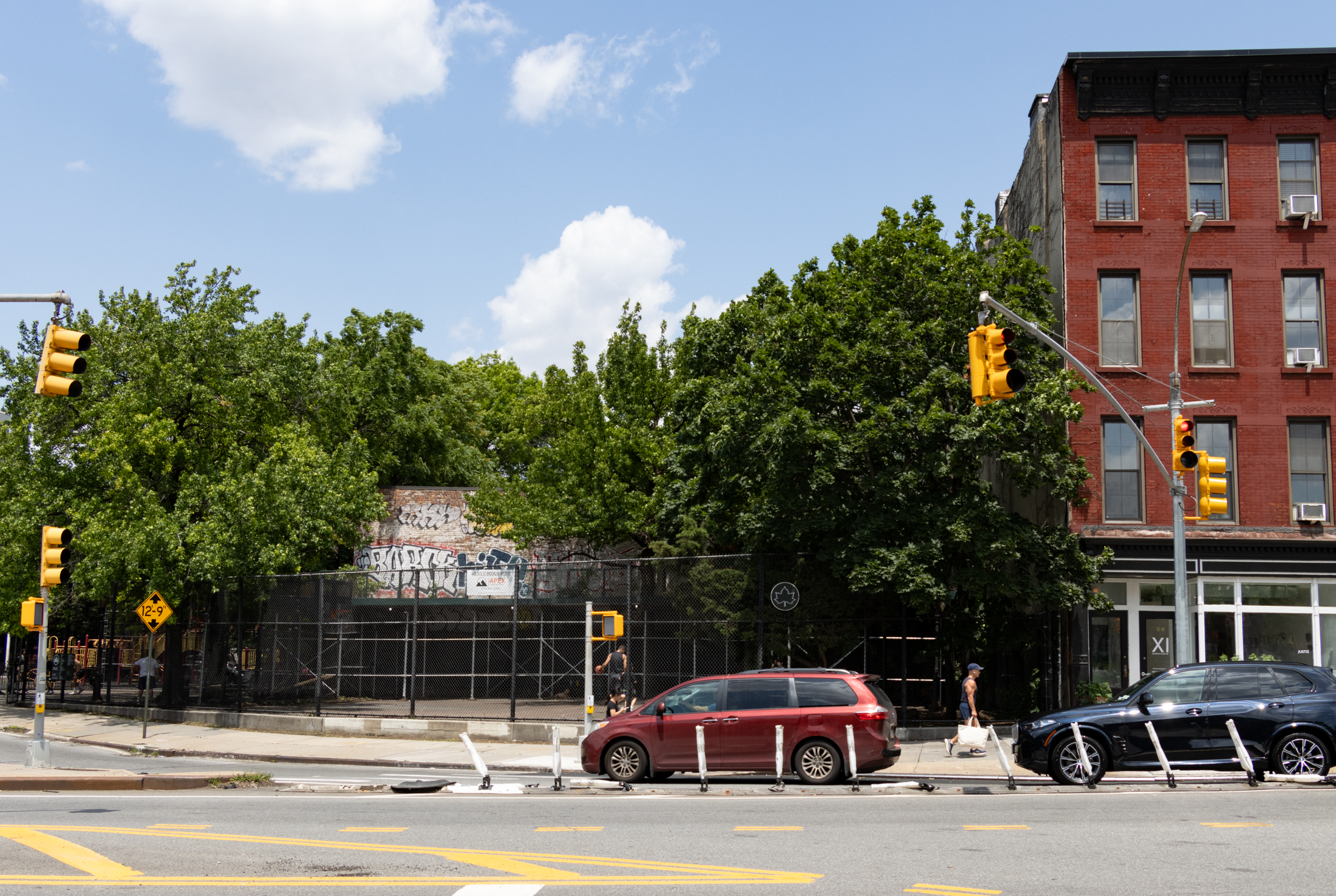 view of basketball court and back of building abutting the adam yauch park