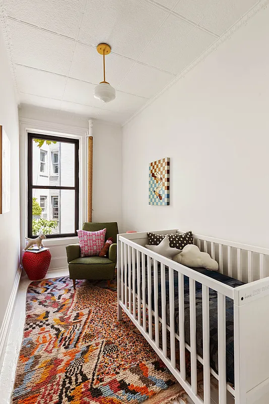narrow bedroom set up as a nursery
