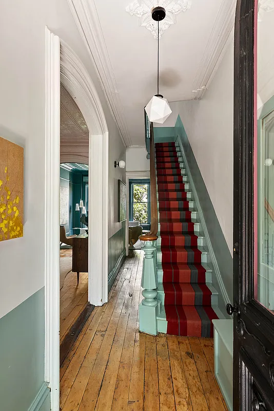 entry with stair painted green, a wide plank wood floor