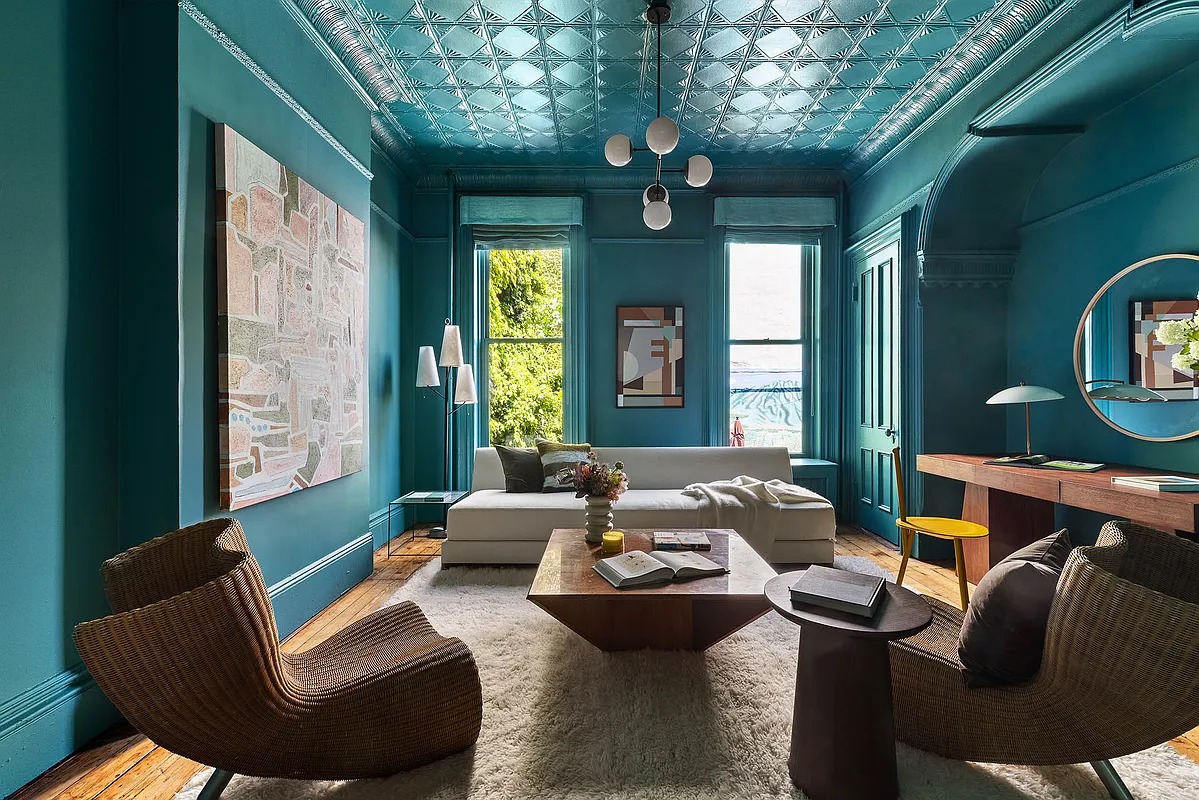 rear parlor with bold green walls, tin ceiling also painted green