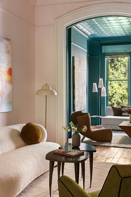 view from front parlor with pale walls to rear parlor with bold green walls