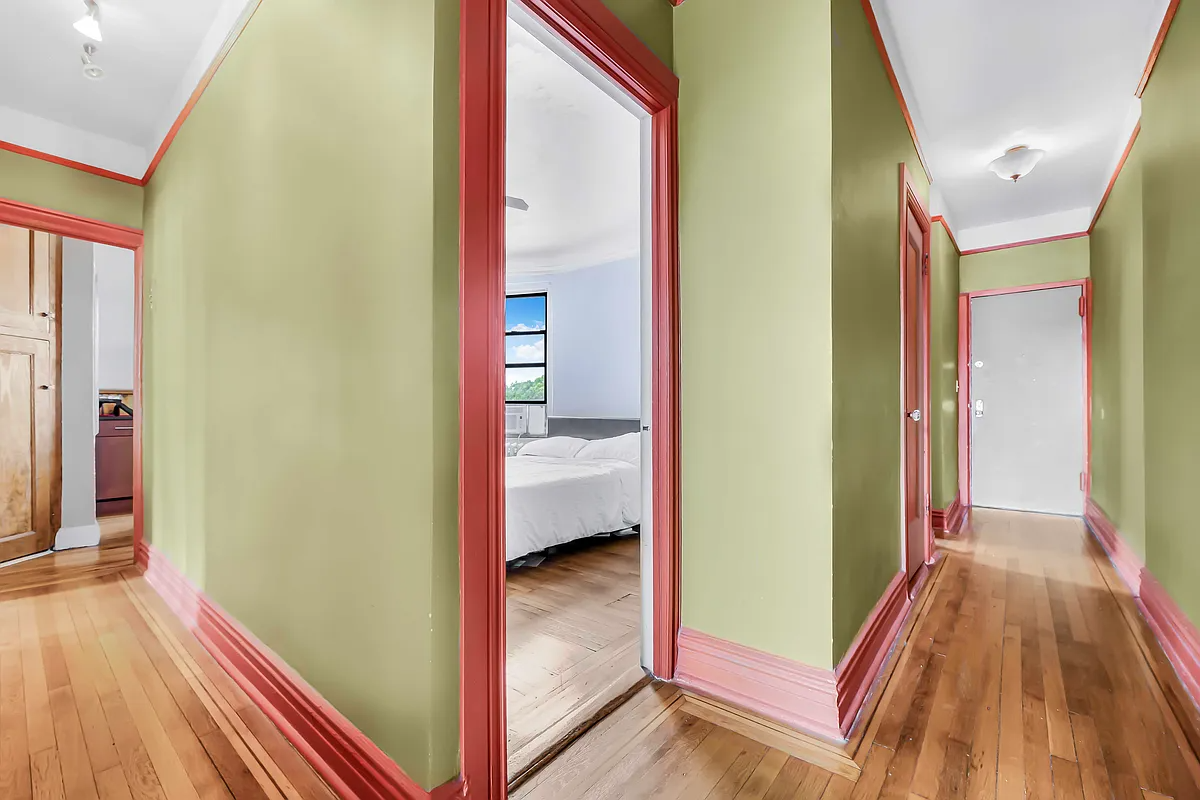 hallway with green walls and red trim