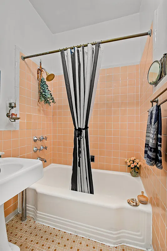 bathroom with peach wall tiles, white fixtures