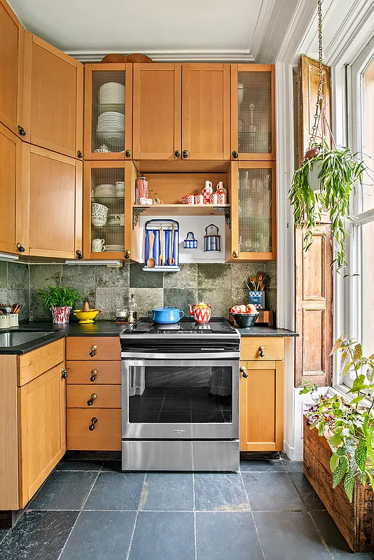 petite windowed kitchen with wood cabinets