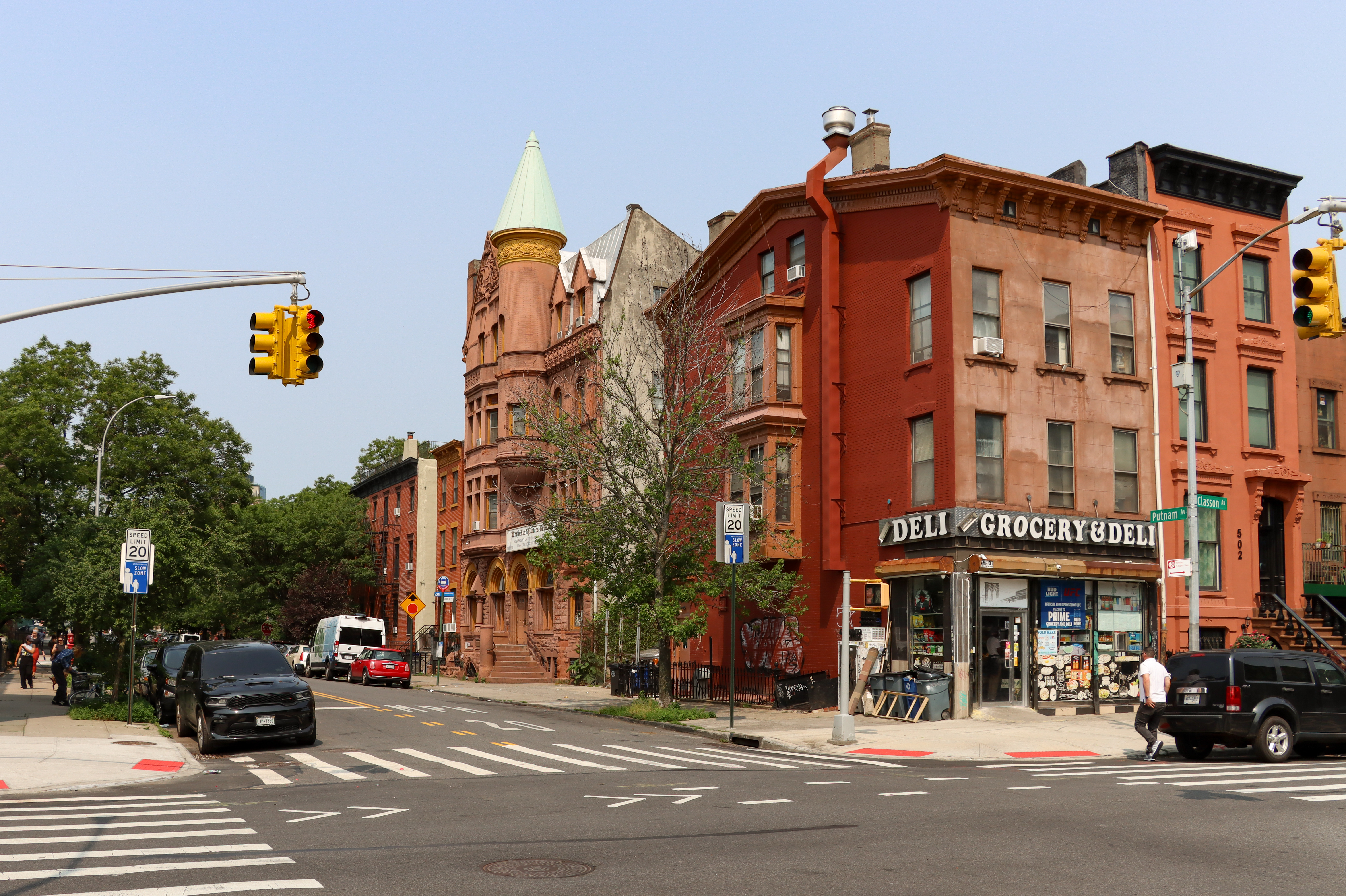 brooklyn - streetcorner with a bodega and a view of brick and brownstone houses