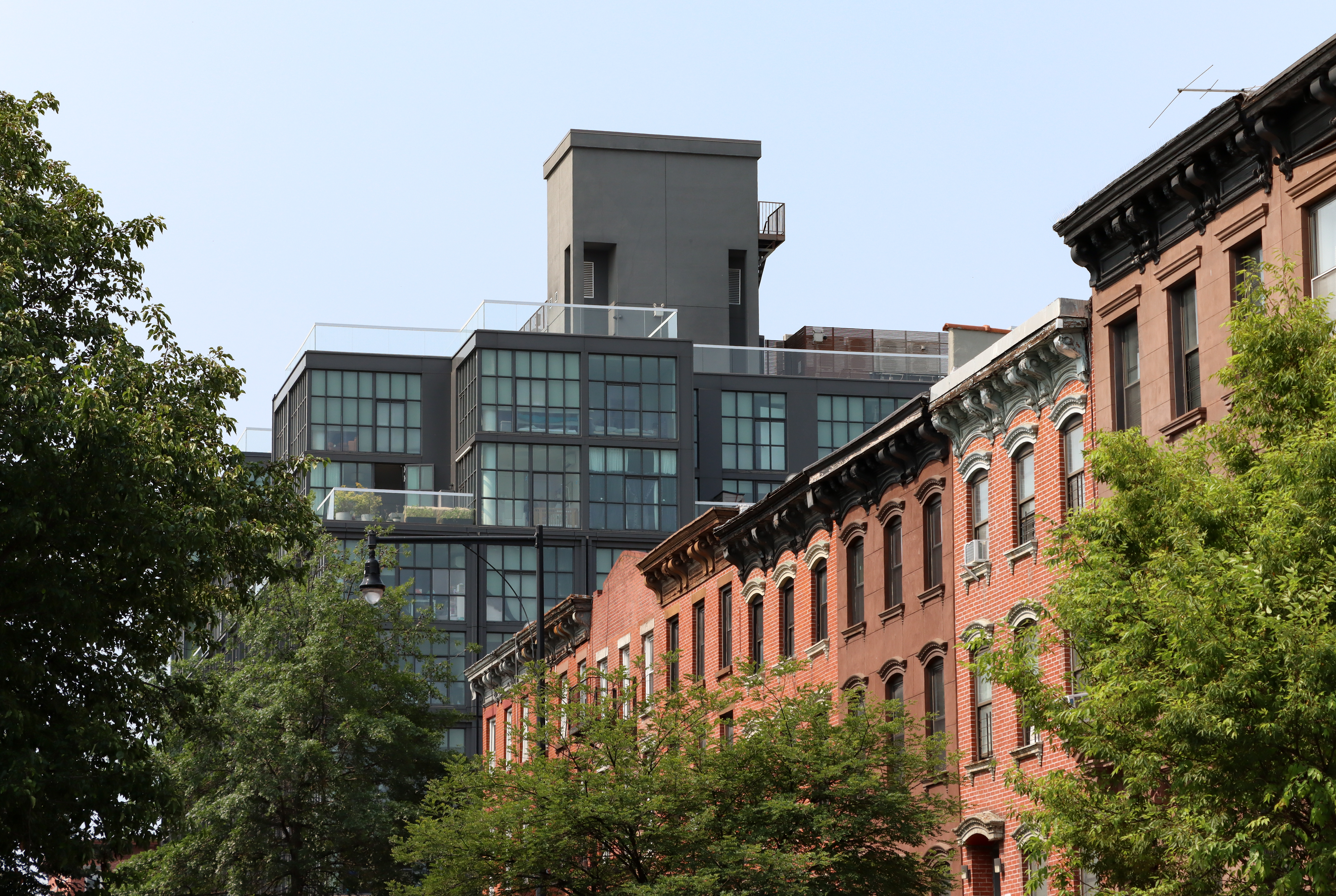 brooklyn - brick and brownstone row on franklin avenue with new housing in the background