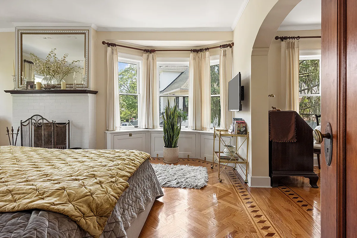 bedroom with arched entry to a dressing room