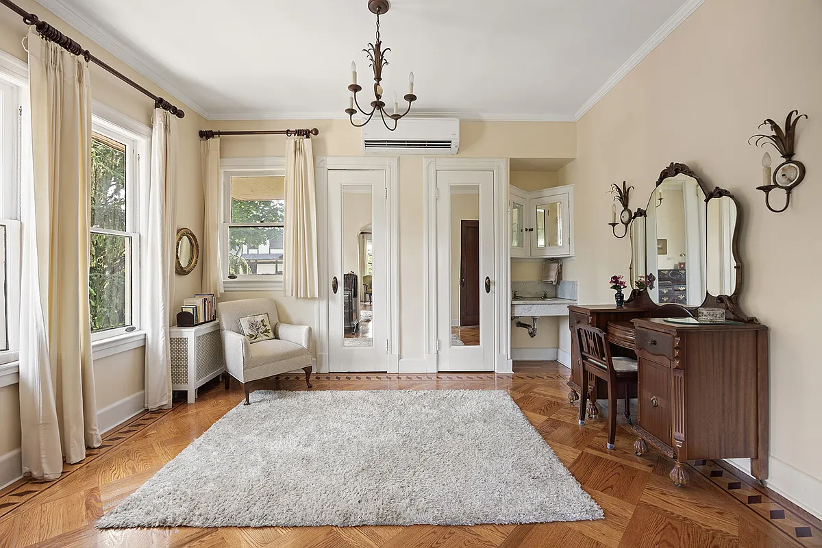 bedroom with two exposures, marble sink with original medicine cabinets, wood floor
