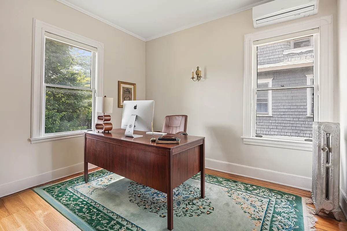 bedroom with wood floor set up as an office