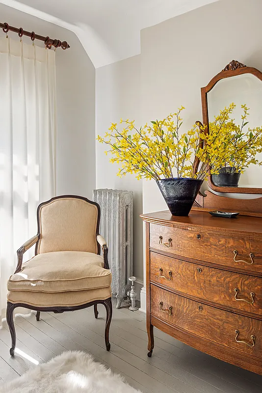detail of bedroom with painted wood floor