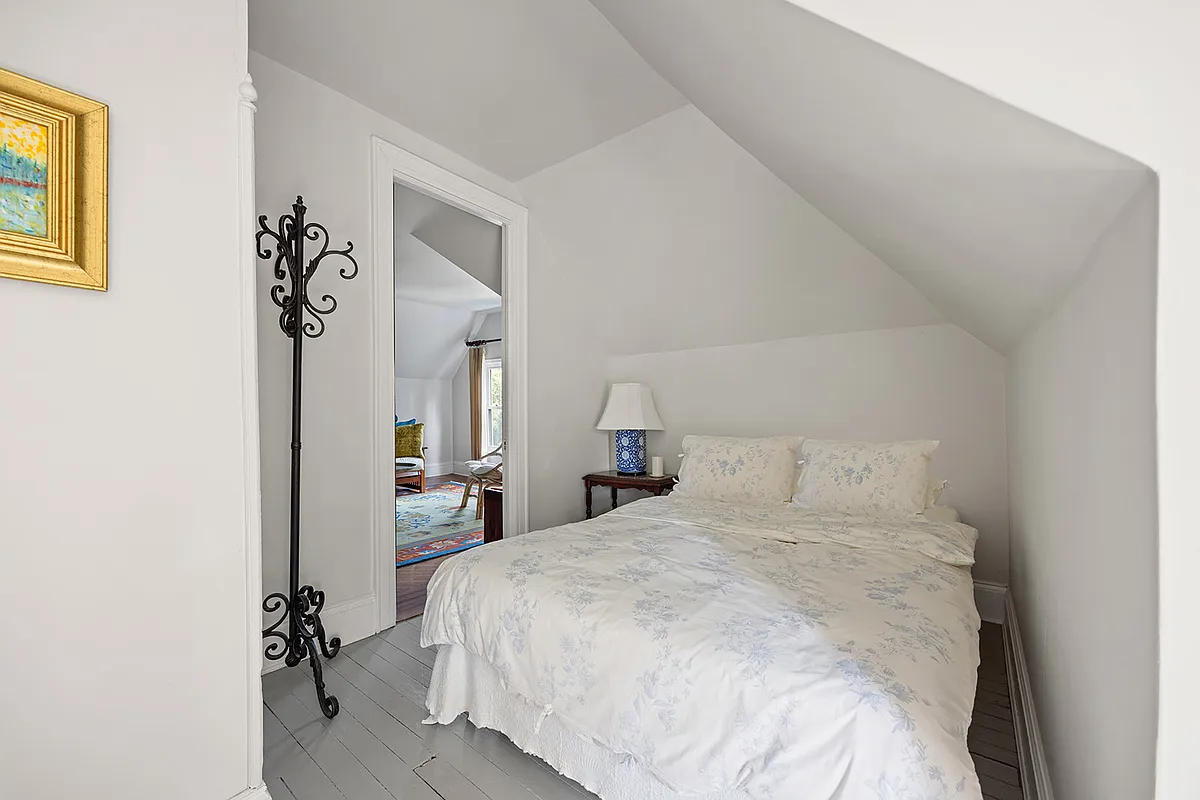 small bedroom with gray painted floor