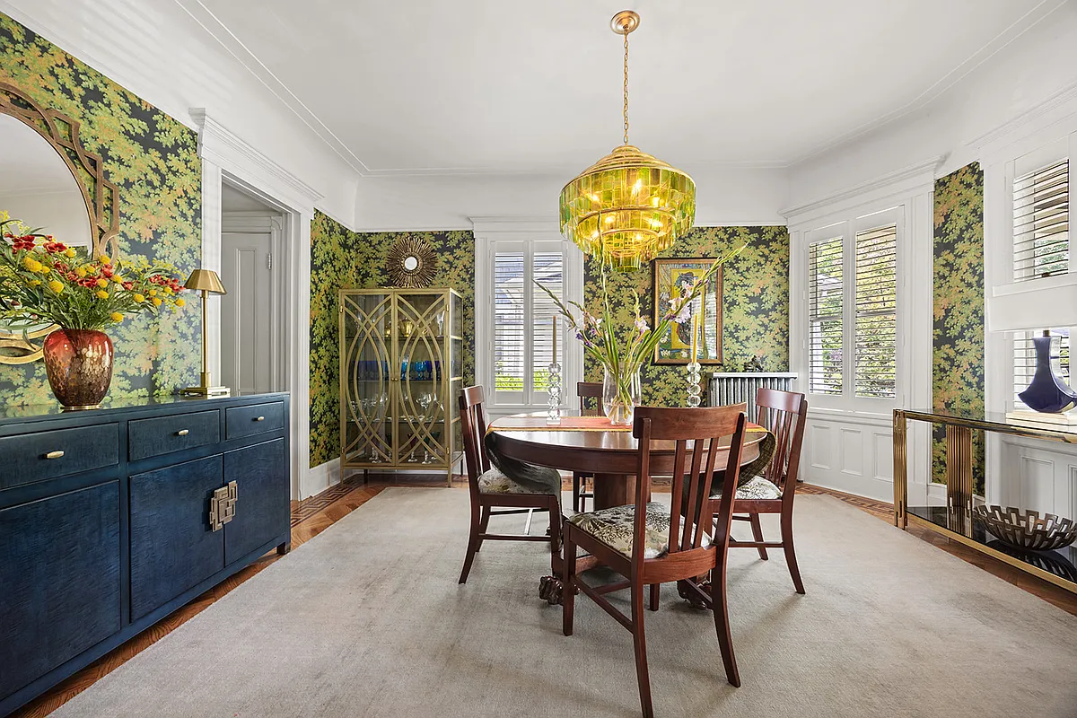 dining room with bold, tree wallpaper