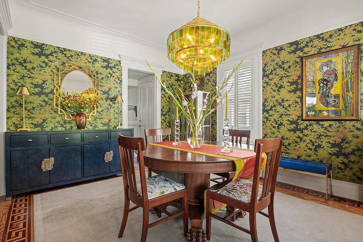 dining room with bold, tree wallpaper