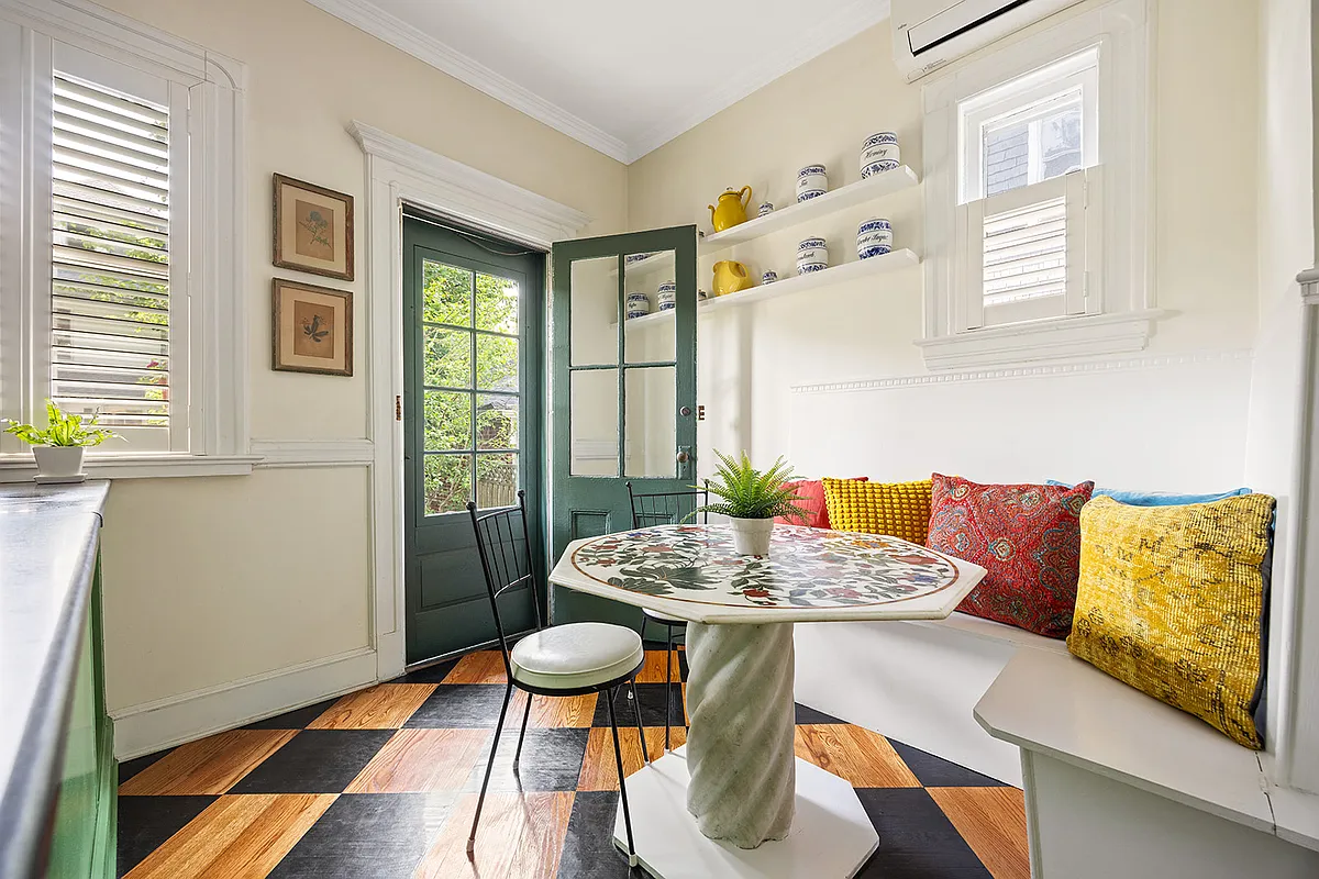 built-in corner banquet in the kitchen next to a door to the rear yard
