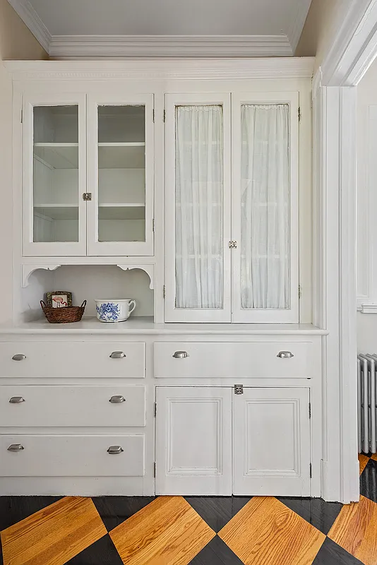 built-in cabinet in the kitchen painted white