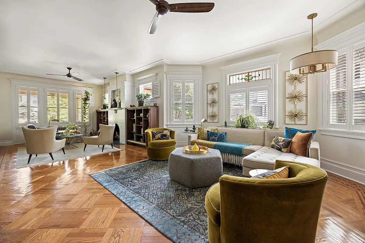 living room with ceiling fans, wood floor, two exposures