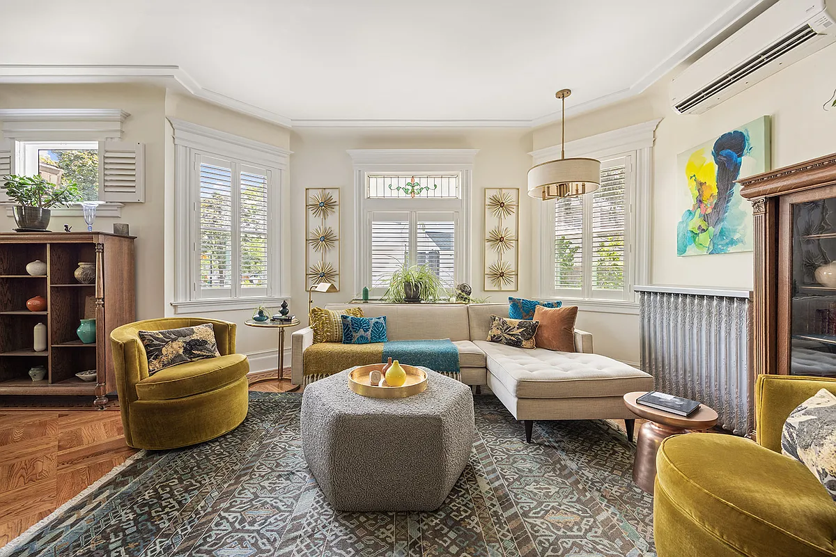 living room seating area with stained glass window, mini split