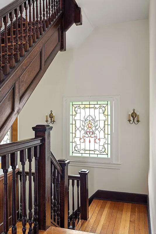 stair with stained glass window near a landing