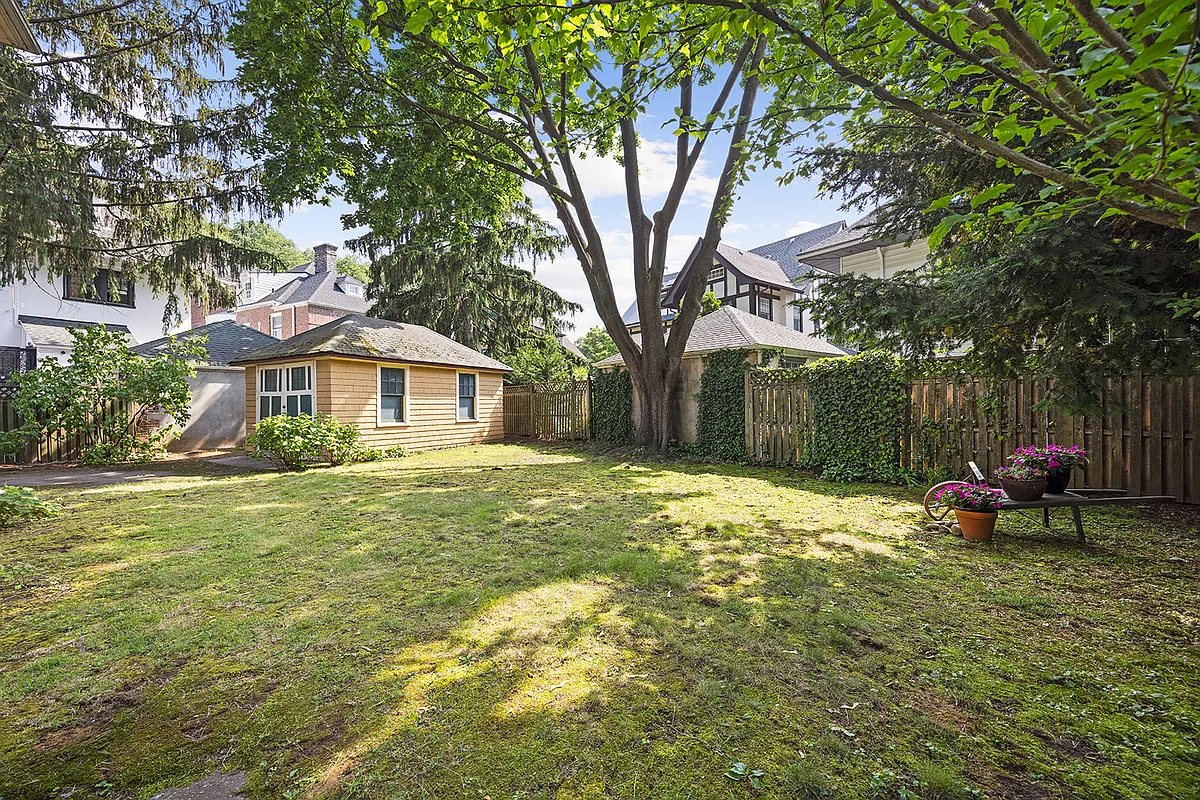 yard with a lawn and a view to the garage