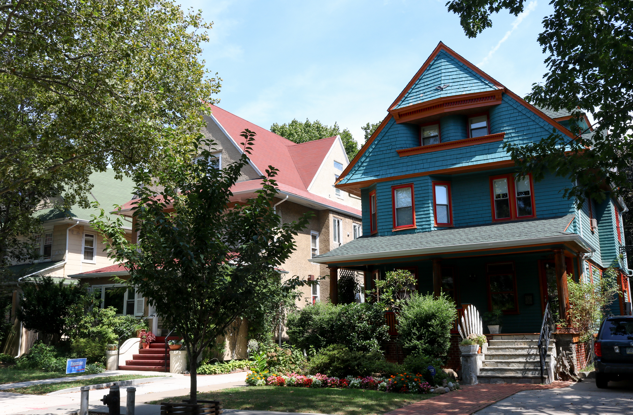 freestanding house painted blue with red trim