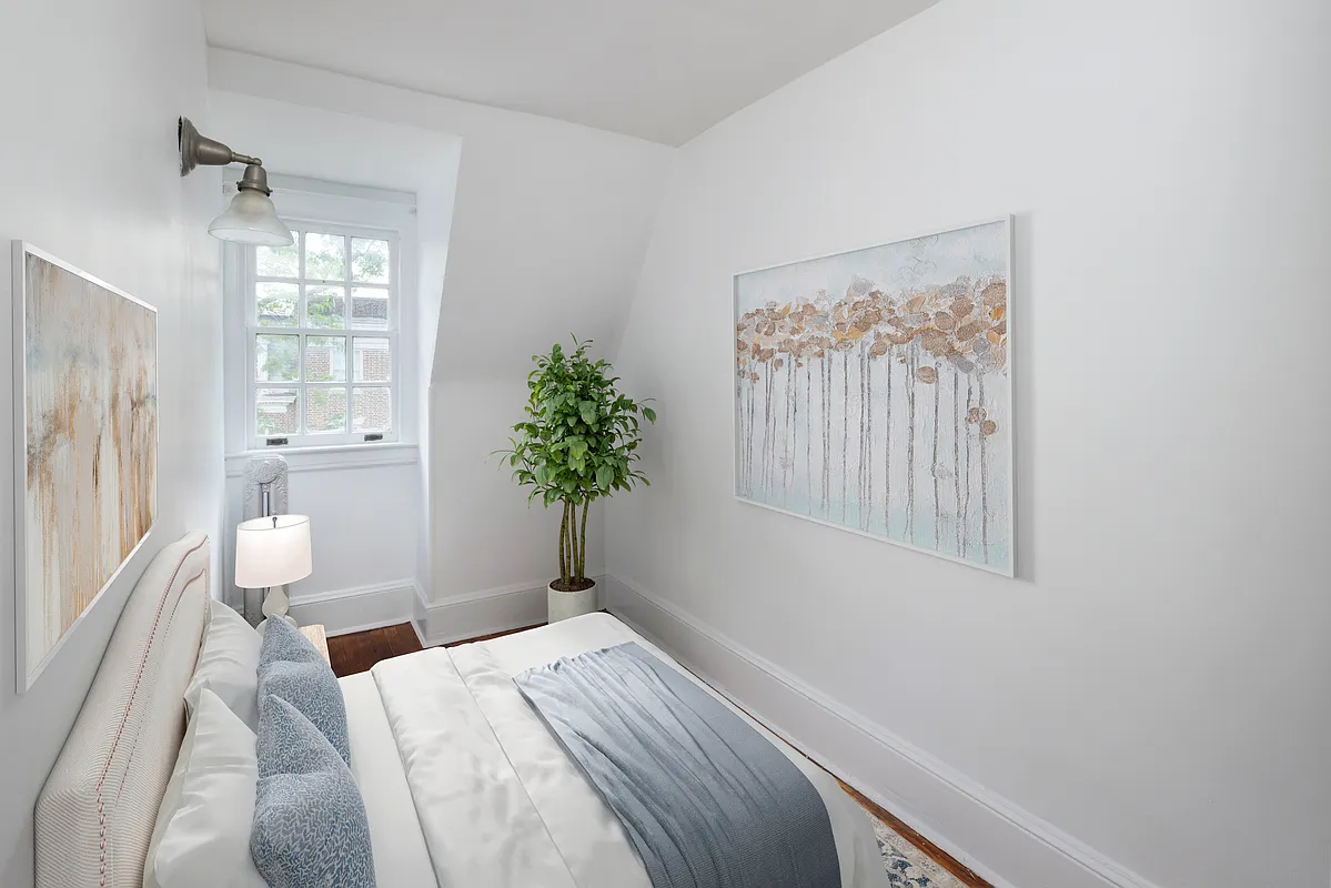 virtually staged, narrow bedroom with bed