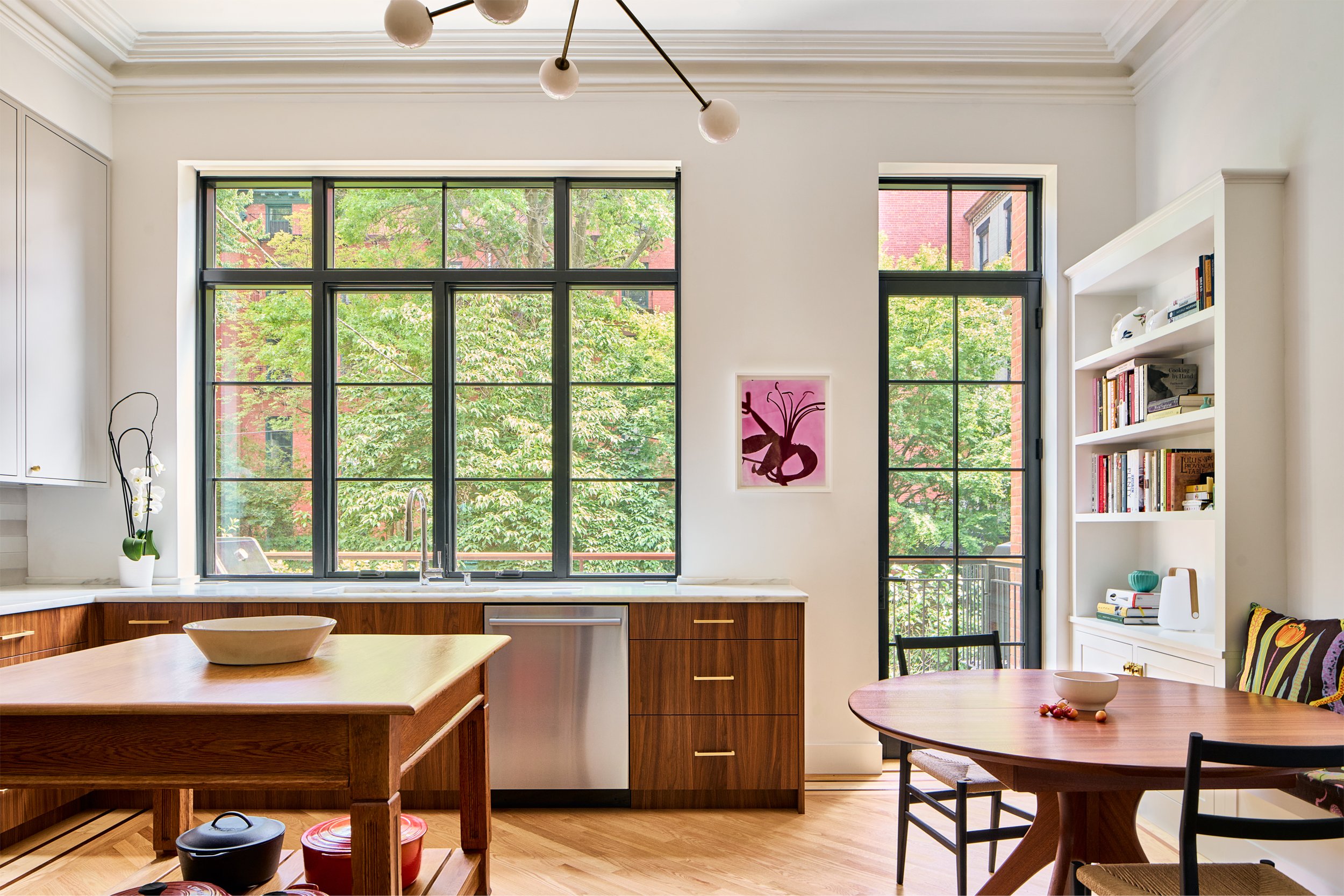 kitchen with a door and large windows looking to the rear yard
