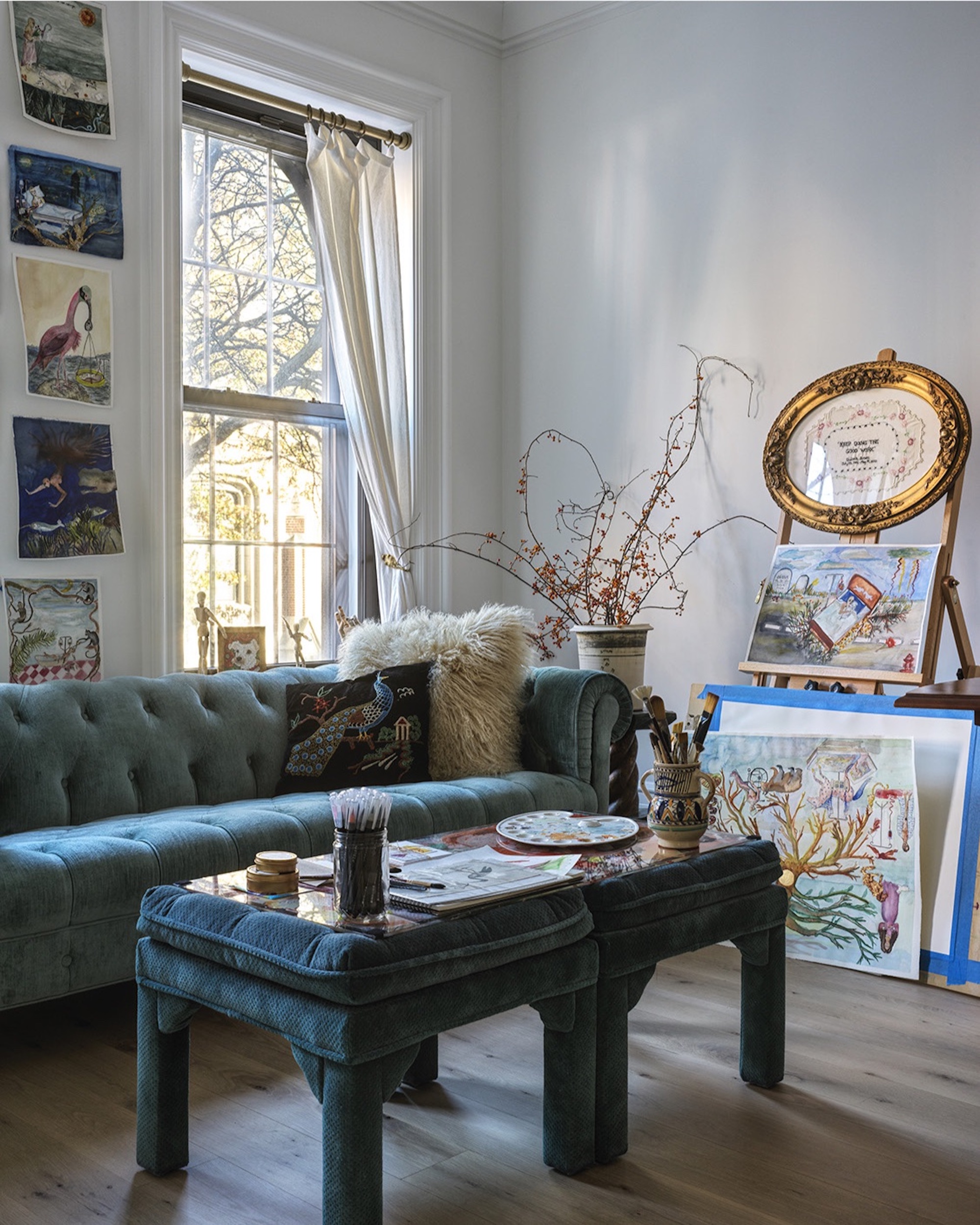 BLUE VELVET TUFTED SOFA ART PROPPED ON WALL