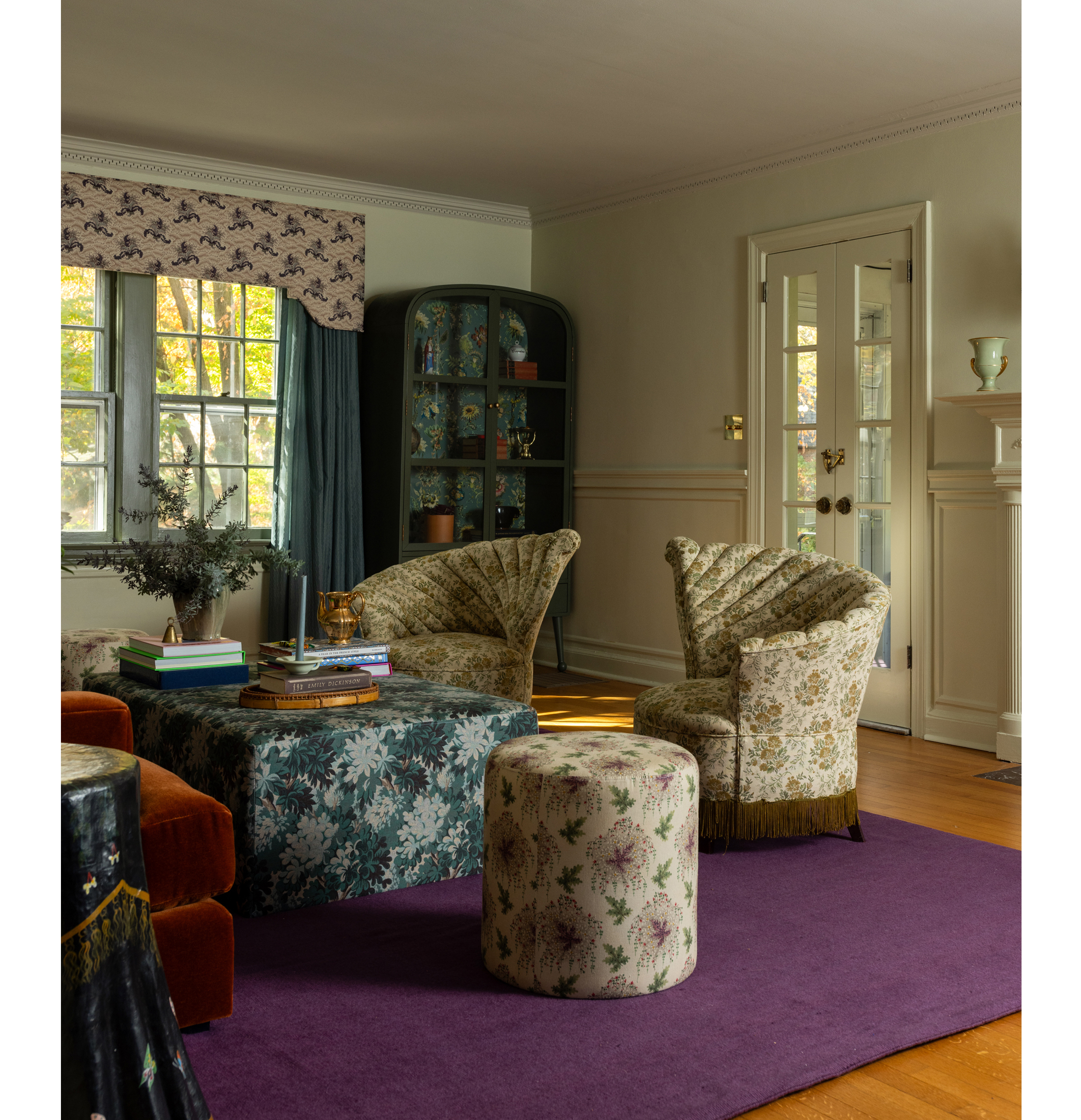 living room with purple rug, curved furniture