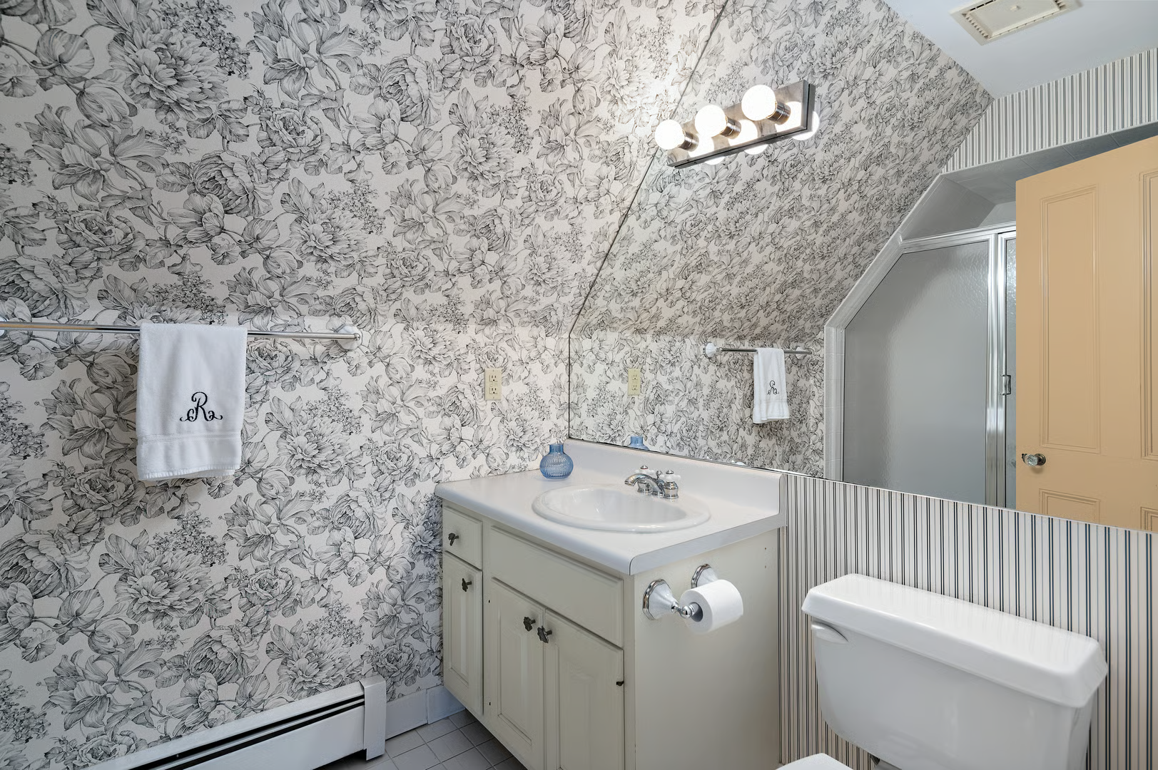bathroom with black and white floral wallpaper