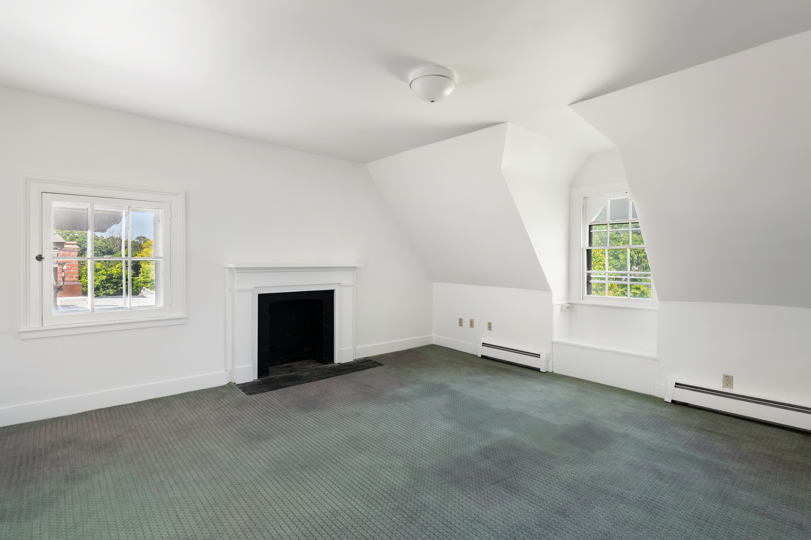 top floor bedroom with wall-to-wall carpet and a mantel
