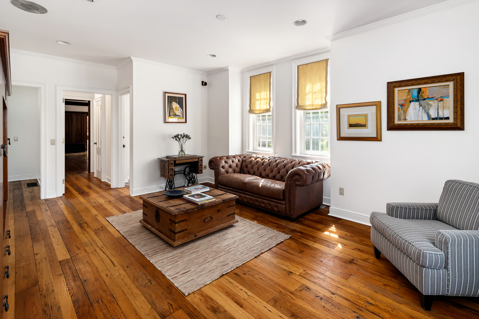 informal living room with wood floor, white walls, recessed lighting