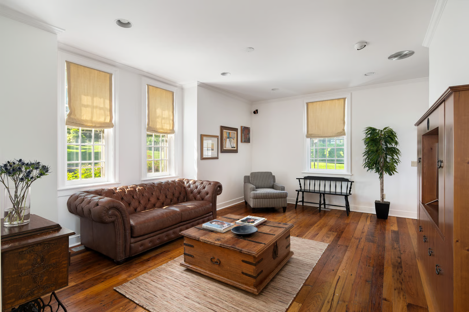 informal living room with wood floor, white walls, recessed lighting